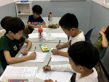 students practicing writing