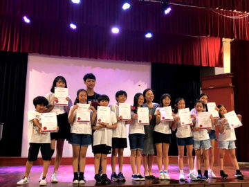 camp kids with their certificates on a stage
