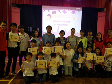 camp kids posing with graduation certificates