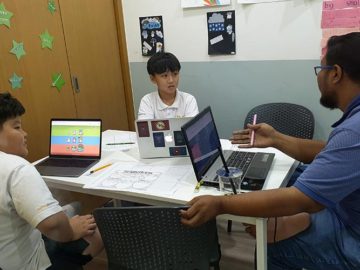 Students and Teacher working on computers