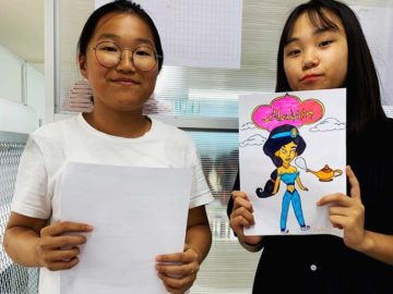 Students showing off Aladdin Comic Book