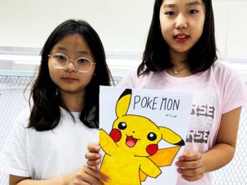 Students showing off pokemon comic