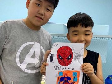 Students showing off Spiderman Comic book