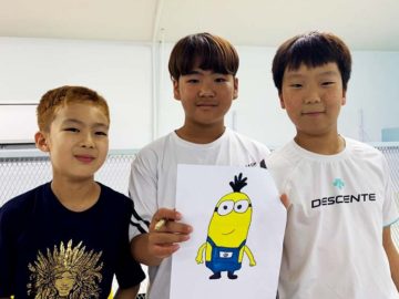 Students showing off minions comic