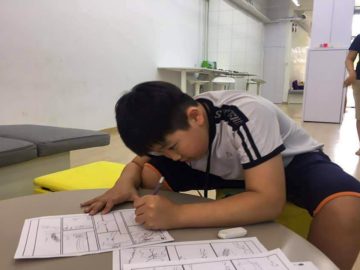 Student working on drawing a comic